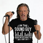 Man in black t-shirt with "I'M THE SOUND GUY" graphic, holding microphones.