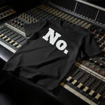 Black t-shirt with "No." in large white block letters, displayed on a soundboard.