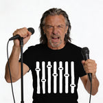 Man in black t-shirt with equalizer graphic holds two microphones, shouting.