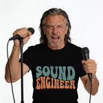 Man holding two microphones with "SOUND ENGINEER" text on his t-shirt.